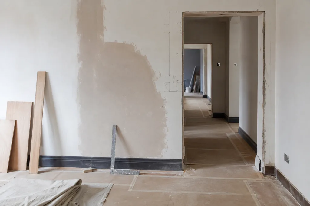 An orderly renovation space with protected floors and measured set-out marks